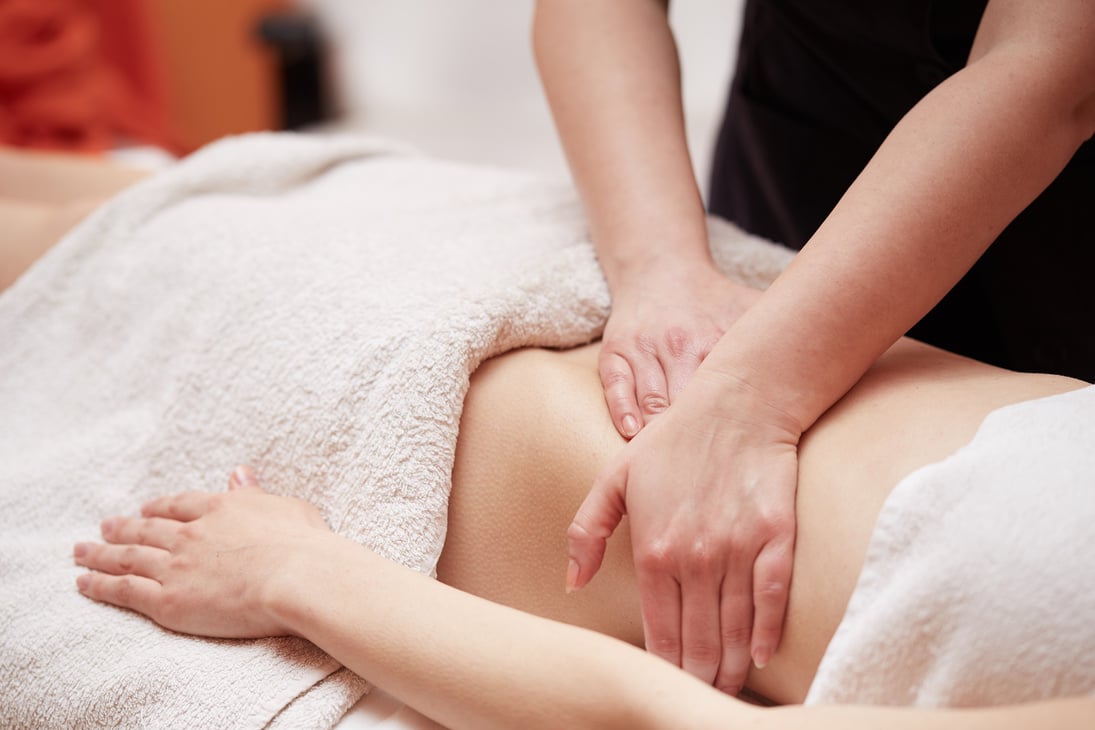 Beautiful girl having stomach massage